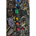 BrassBound Pages Cassian Spectrum close-up showing emerald centre stone, rainbow gems, owl charm, mushrooms and chained clockwork details