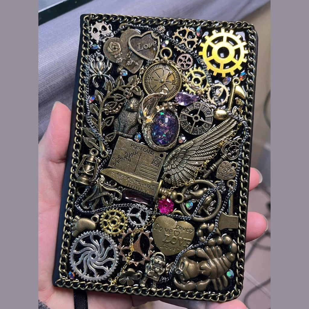 BrassBound Pages Seraphine Nightwing handmade steampunk journal with compass, metal wing, key charm, layered gears and iridescent galaxy stone cover