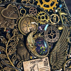 BrassBound Pages Seraphine Nightwing handmade steampunk journal close-up with compass clock, antique gears, wing detail, and iridescent galaxy stone with purple crystal accent