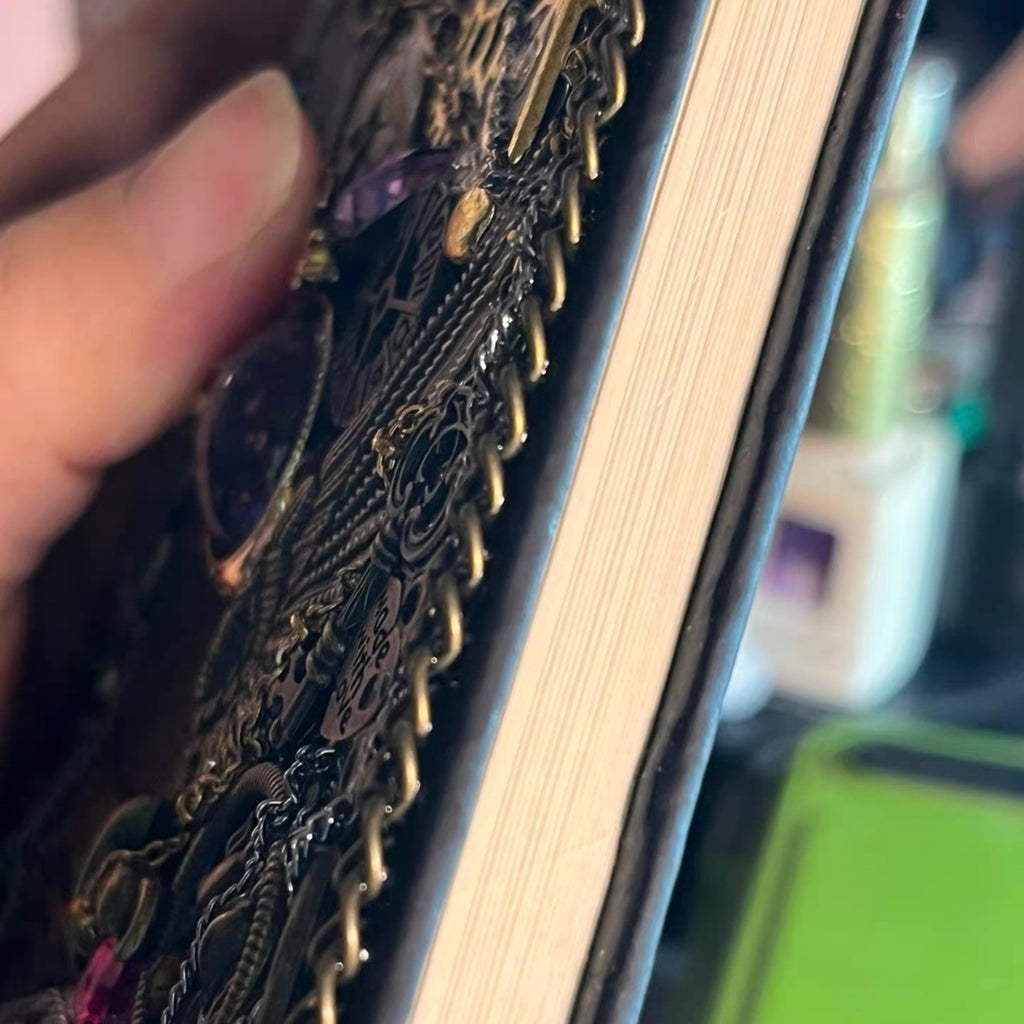 BrassBound Pages Seraphine Nightwing handmade steampunk journal side view showing layered metal cover depth, braided trim, and thick lined pages